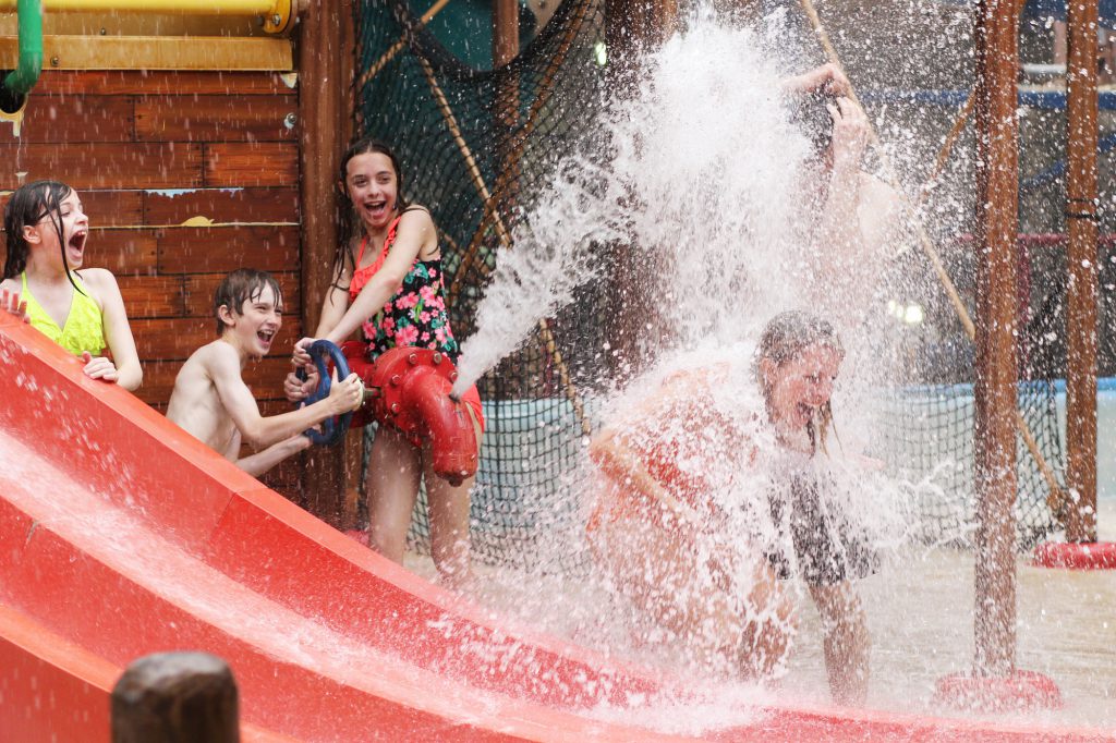 Girl getting splashed at waterpark