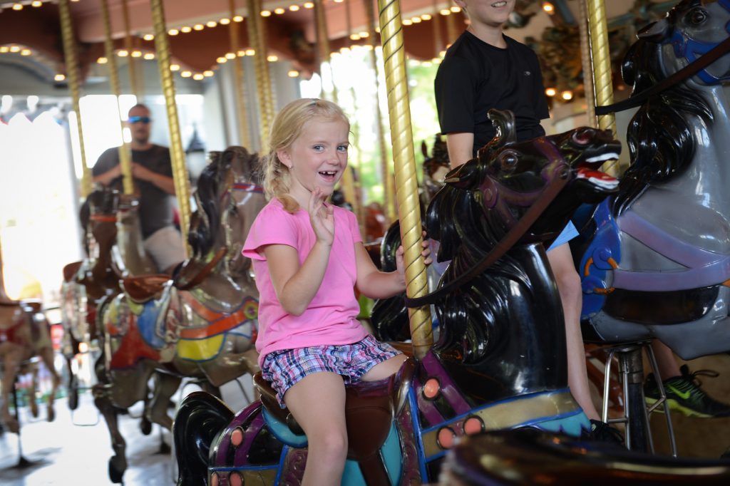 Girl riding the carousel